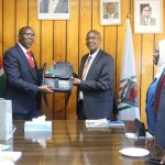Egerton University Deputy Vice Chancellor, Administration, Finance and Planning, Prof. George Muthaa, presents a gift to the Institution of Engineers of Kenya (IEK) delegation during its courtesy visit to the University.