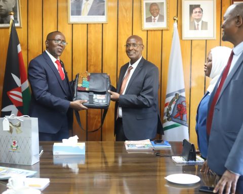 Egerton University Deputy Vice Chancellor, Administration, Finance and Planning, Prof. George Muthaa, presents a gift to the Institution of Engineers of Kenya (IEK) delegation during its courtesy visit to the University.