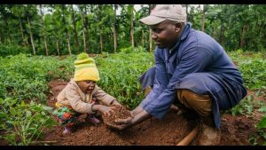 An African farmer with his kid in a farm