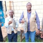 Uasin Gishu Agriculture CECM Sam Kotut (second right) with county officials holding fish from Kesses Dam