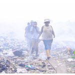 People walking in a land fill in Africa