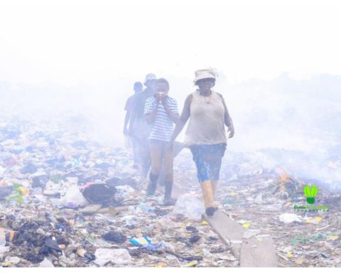 People walking in a land fill in Africa